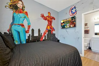 a bedroom with a superhero mural on the wall at Windsor Hills Marvel Themed Home with Private Pool in Orlando