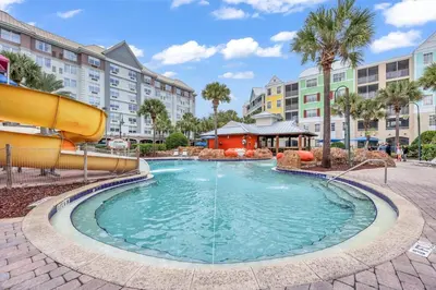 a pool at a resort with a slide at Family Resort Condo Disney 5 miles in Kissimmee
