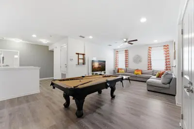 a living room with a pool table in it at Chic Modern Escape 12BR Pool and Game Room in Kissimmee