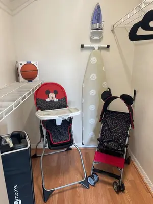 a room with two chairs and a rack with a surfboard at 