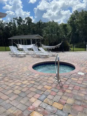 a pool with lounge chairs and a gazebo at 