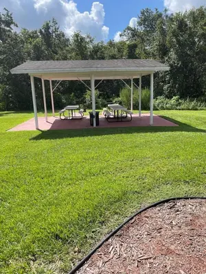 a gazebo with two benches in a park at 