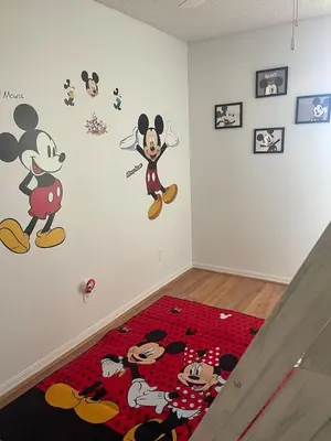 a room with mickey mouse decals on the wall at 