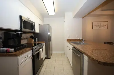 a kitchen with a sink and a stove top oven at 