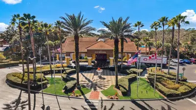an aerial view of a resort with palm trees at 3179 Yellow Lantana Lane in Kissimmee