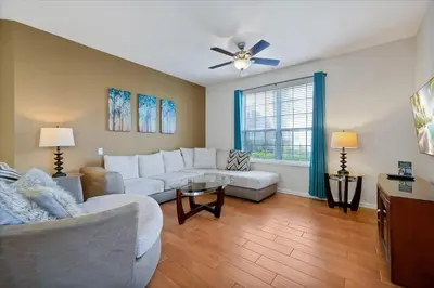 a living room with white furniture and a ceiling fan at Beautiful Condo, Near Epic Universe and OCCC-2018 by Vista Cay Resort in Orlando