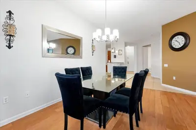 a dining room with a glass table and black chairs at Beautiful Condo, Near Epic Universe and OCCC-2018 by Vista Cay Resort in Orlando