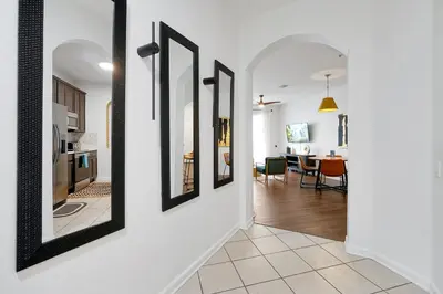 a hallway with a row of mirrors on a wall at Luxury 2BR Epic Universe Condo at Vista Cay 3029 by Vista Cay Resort in Orlando