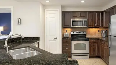 a kitchen with a sink and a stove top oven at Orange Lake Vacation Time in Orlando