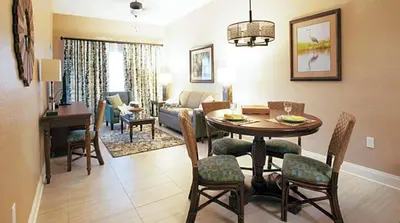 a living room with a table and a dining room at Orange Lake Vacation Time in Orlando