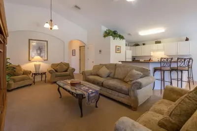 a living room with two couches and a table at Private Pool with spa and Game Room Near Disney in Kissimmee