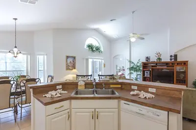 a kitchen with a sink and a dining room at Private Pool with spa and Game Room Near Disney in Kissimmee