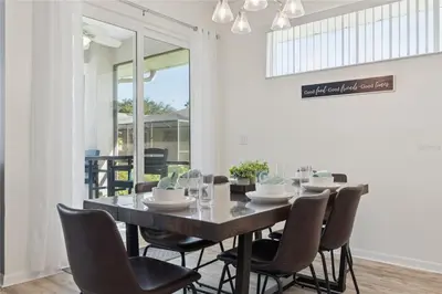 a dining room with a table and chairs at Disney World, Universal Epic Waterfront Modern Home - Private Pool And Game Room in Kissimmee