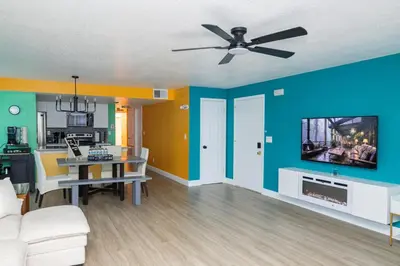 a living room with a couch and a flat screen tv at 3BR Disney Home with Pool , Arcade and Hot Tub in Kissimmee