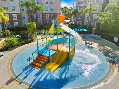 a water park with a slide in the water at Vista Cay Resort Near Parks Convention Center in Orlando