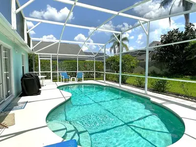 a swimming pool in a house with a glass roof at Minutes from Disney Themed 2 Bd Villa with Private Pool home in Orlando
