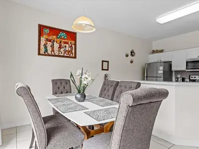 a kitchen and dining room with a table and chairs at 4bd Villa Near Epic Universe and Disney with private Pool townhouse in Kissimmee