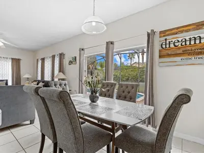 a dining room with a table and chairs at 4bd Villa Near Epic Universe and Disney with private Pool townhouse in Kissimmee