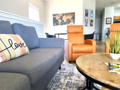 a living room with a couch and a table at Very Near Disney 3 Bd Condo Walmart 1 min away townhouse in Orlando