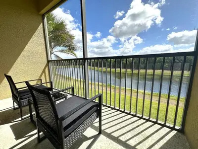 a balcony with a bench and a view of the water at Very Near Disney 3 Bd Condo Walmart 1 min away townhouse in Orlando