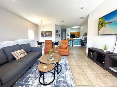 a living room with a couch and a table at Very Near Disney 3 Bd Condo Walmart 1 min away townhouse in Orlando