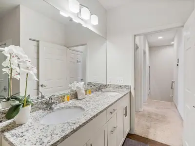 a bathroom with two sinks and a large mirror at Elegant Townhome at West Lucaya in Kissimmee