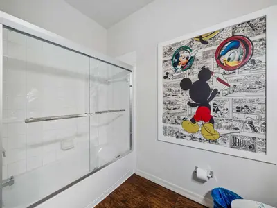 a bathroom with a shower and a painting on the wall at Elegant Townhome at West Lucaya in Kissimmee