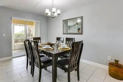 a dining room with a black table and chairs at 5 Mi to WDW! Spacious Resort Escape with Pool Access in Kissimmee