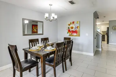 a dining room with a table and chairs at 5 Mi to WDW! Spacious Resort Escape with Pool Access in Kissimmee