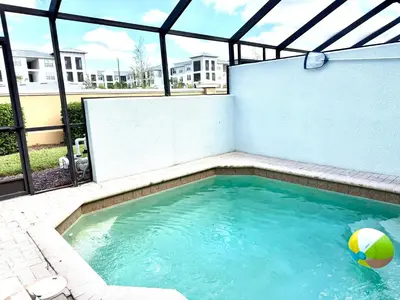 a swimming pool with a beach ball in the water at Affordable Suite Near Disney World, Universal Studios & SeaWorld in Orlando