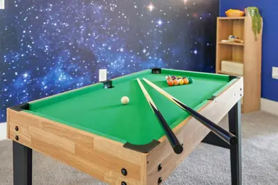 a pool table in a room with a star wall at Casita Coco - Private Pool - Foosball - BBQ in Kissimmee