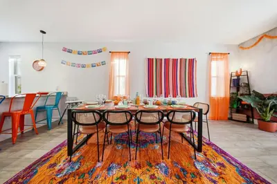 a dining room with a table and chairs on a rug at Casita Coco - Private Pool - Foosball - BBQ in Kissimmee