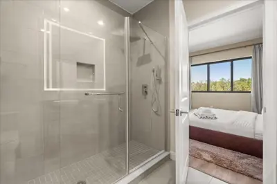 a bathroom with a shower with a glass door at 5565Torino in Kissimmee