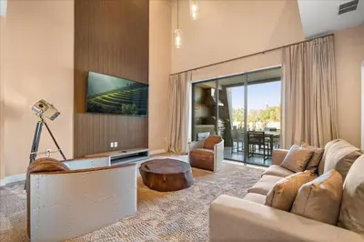 a living room with a couch and a table and a tv at 5565Torino in Kissimmee