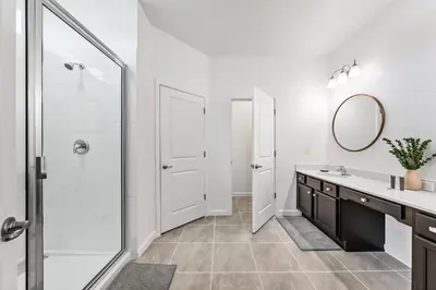 a bathroom with a shower and a sink and a mirror at Resort-Style Living w Private Pool & Amenities in Kissimmee