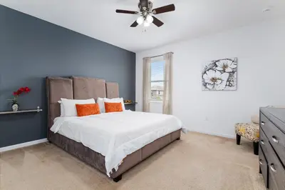 a bedroom with a bed and a ceiling fan at 9 BR Family Home 8 Min to Disney SON104 in Kissimmee
