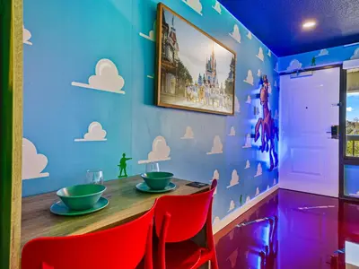 a dining room with a table and red chairs at Toy Story Magic Studio Close to Disney in Kissimmee