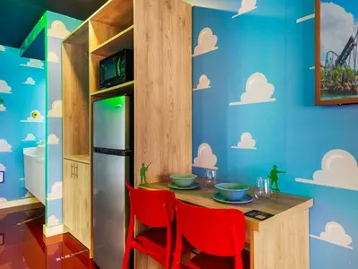 a dining room with a table and red chairs at Toy Story Magic Studio Close to Disney in Kissimmee