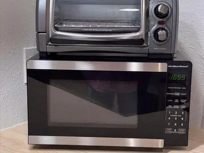 a toaster oven sitting on top of a microwave at Florida vibe suite near Epic Universe & Universal in Orlando