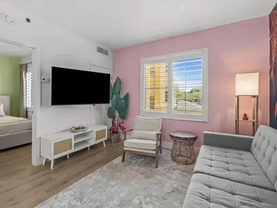 a living room with a couch and a tv at Florida vibe suite near Epic Universe & Universal in Orlando
