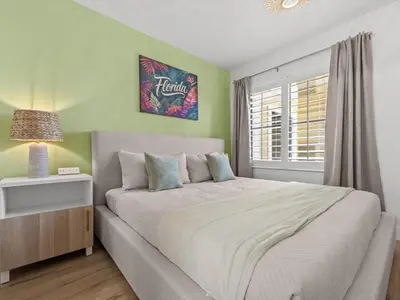 a bedroom with a large bed and a window at Florida vibe suite near Epic Universe & Universal in Orlando