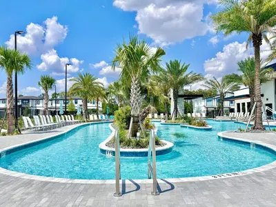 a swimming pool with palm trees in a resort at 2026 NEW 12Bedrooms12Bathroom At Paradiso Grande in Orlando