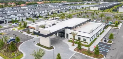 an aerial view of a building with a parking lot at 2026 NEW 12Bedrooms12Bathroom At Paradiso Grande in Orlando