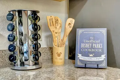 a kitchen counter with a book and some spoons at 10 Mins To Disney NO FEES Heated Pool & Hot Tub in Orlando