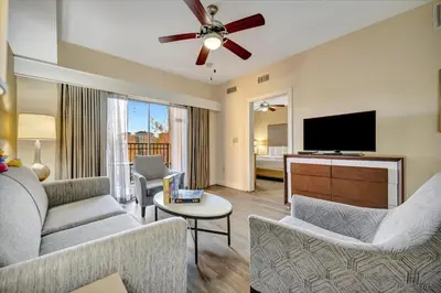 a living room with a couch and a flat screen tv at 10 Mins To Disney NO FEES Heated Pool & Hot Tub in Orlando