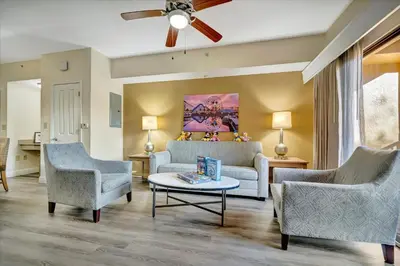 a living room with two chairs and a couch at 10 Mins To Disney NO FEES Heated Pool & Hot Tub in Orlando