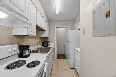 a kitchen with white appliances and a white refrigerator at Modern 1BR with Premium Finishes in Orlando
