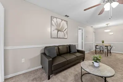 a living room with a couch and a table at Modern 1BR with Premium Finishes in Orlando