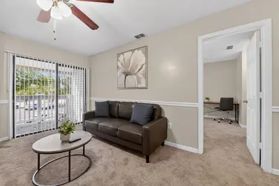 a living room with a couch and a table at Modern 1BR with Premium Finishes in Orlando
