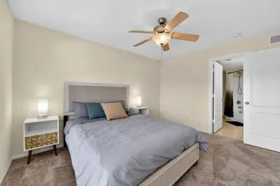 a bedroom with a bed and a ceiling fan at Modern 2BR Stay in Prime Location in Orlando